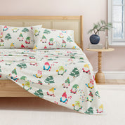 Bed with colorful elf-themed bedding in a bedroom setting