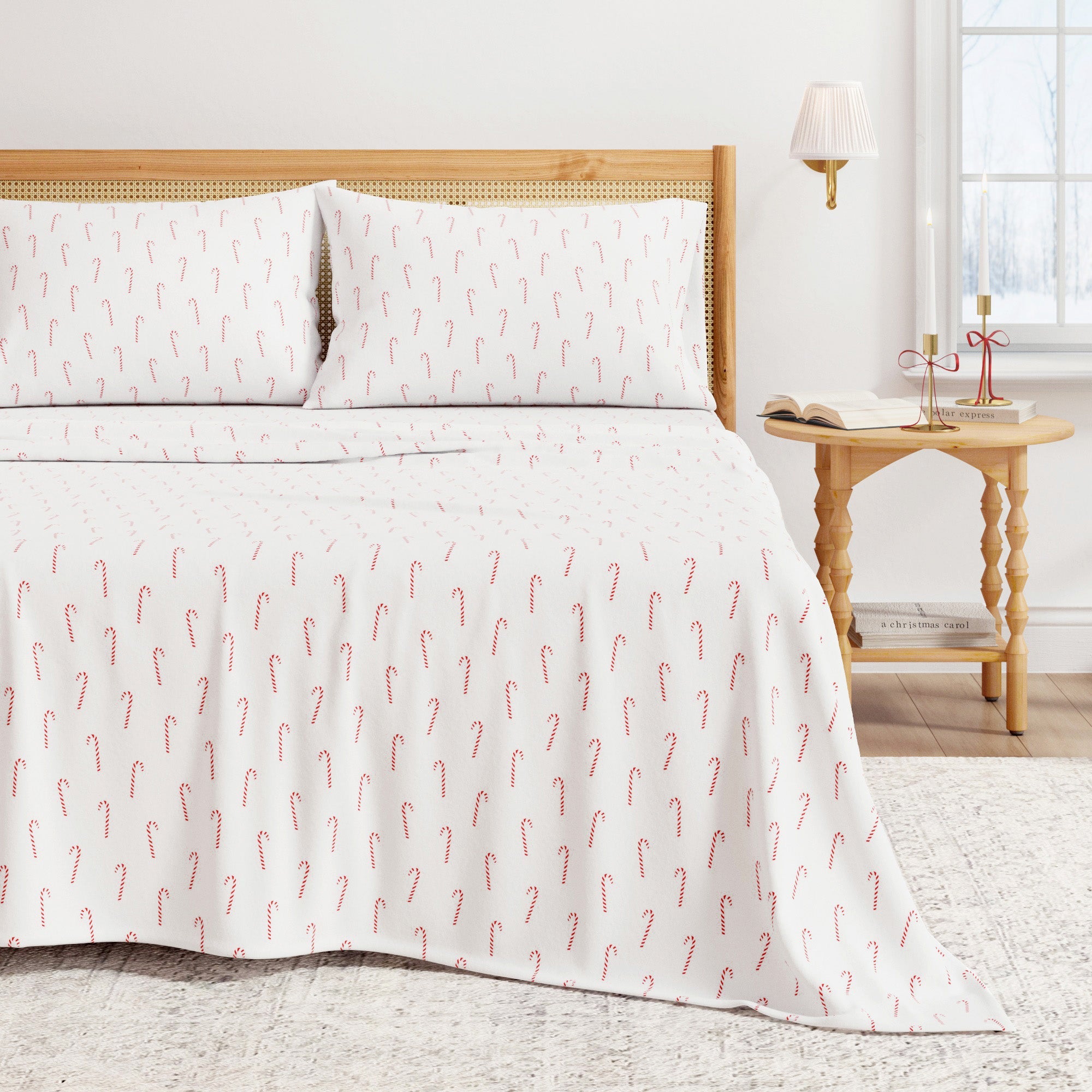 Bed with white bedding featuring red candy cane pattern, wooden headboard and nightstand.