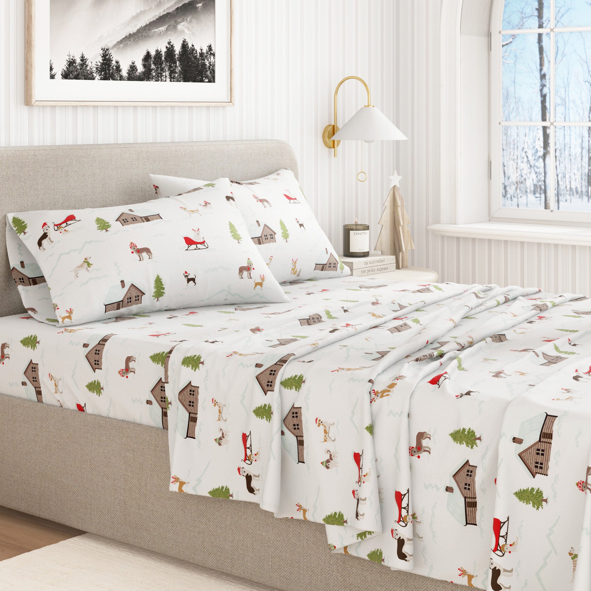 Bed with patterned bedding featuring cabins and trees in a bedroom setting.