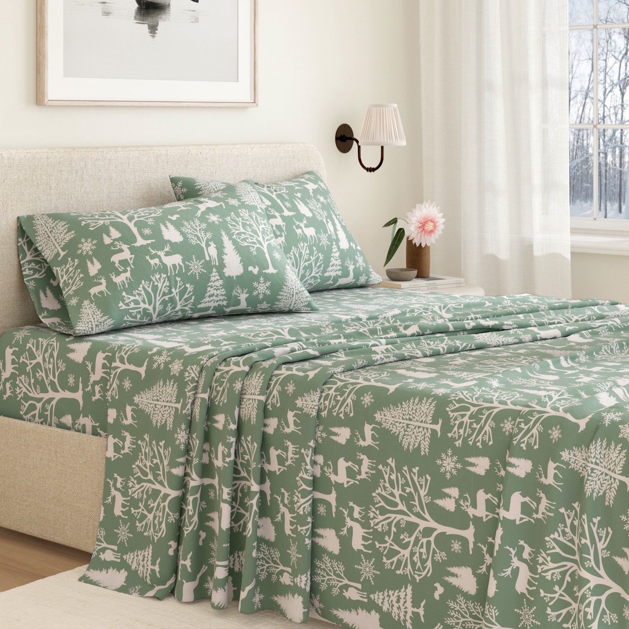 Green and white patterned bedspread on a bed in a bedroom with a lamp and window in the background.