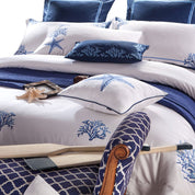 Beach Coastal Bedding Set with ocean-related accessories on a bed 